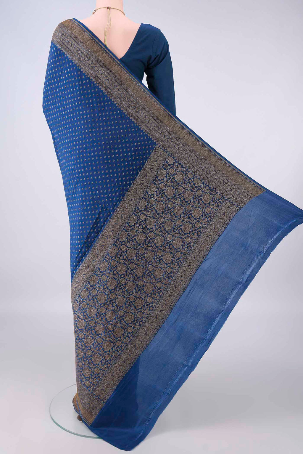 Flat view of Royal Blue Banarasi Georgette Saree with Zari Butta on the body and Zari Border. 
