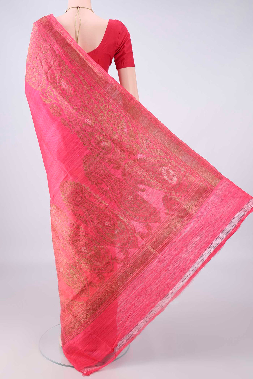 Flat view of Coral Banarasi Tussar Saree with Zari Butta on the body and Zari Border. 