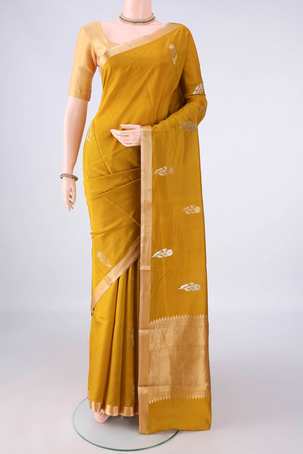 Pure Silk Mustard Banarasi Katan Saree with Zari Butta on the body and Zari Border.  displayed on a mannequin