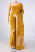 Pure Silk Mustard Banarasi Katan Saree with Zari Butta on the body and Zari Border.  displayed on a mannequin