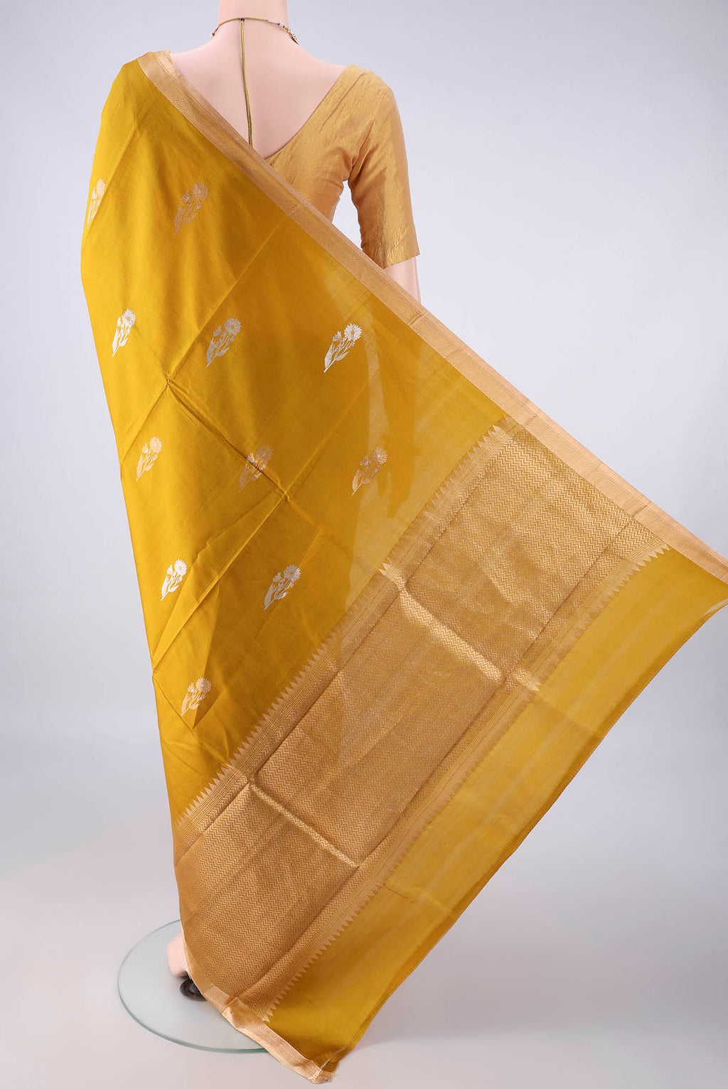 Flat view of Pure Silk Mustard Banarasi Katan Saree with Zari Butta on the body and Zari Border. 