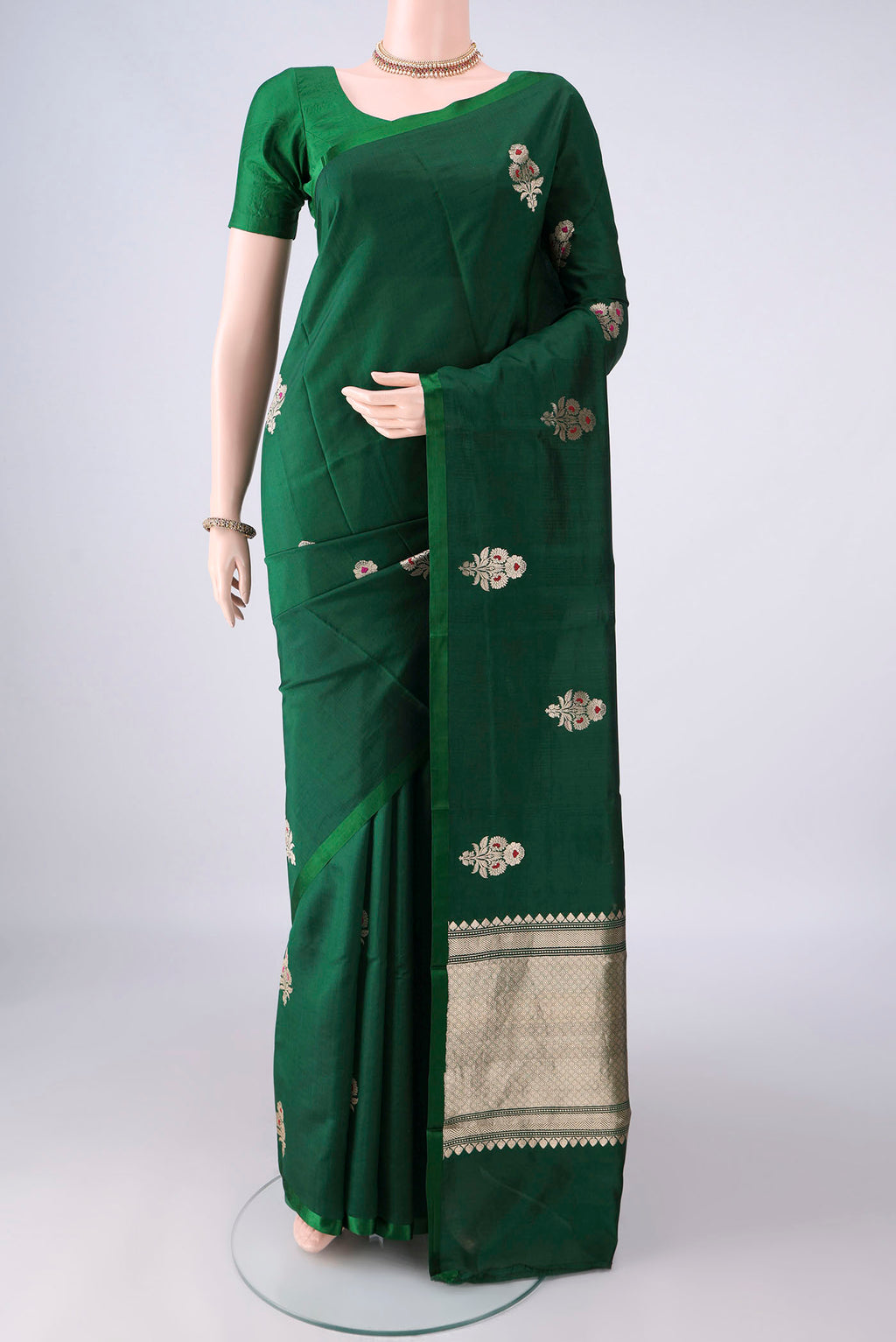 Pure Silk Bottle Green Banarasi Katan Saree with Zari And Thread Butta on the body and Without Border.  displayed on a mannequin