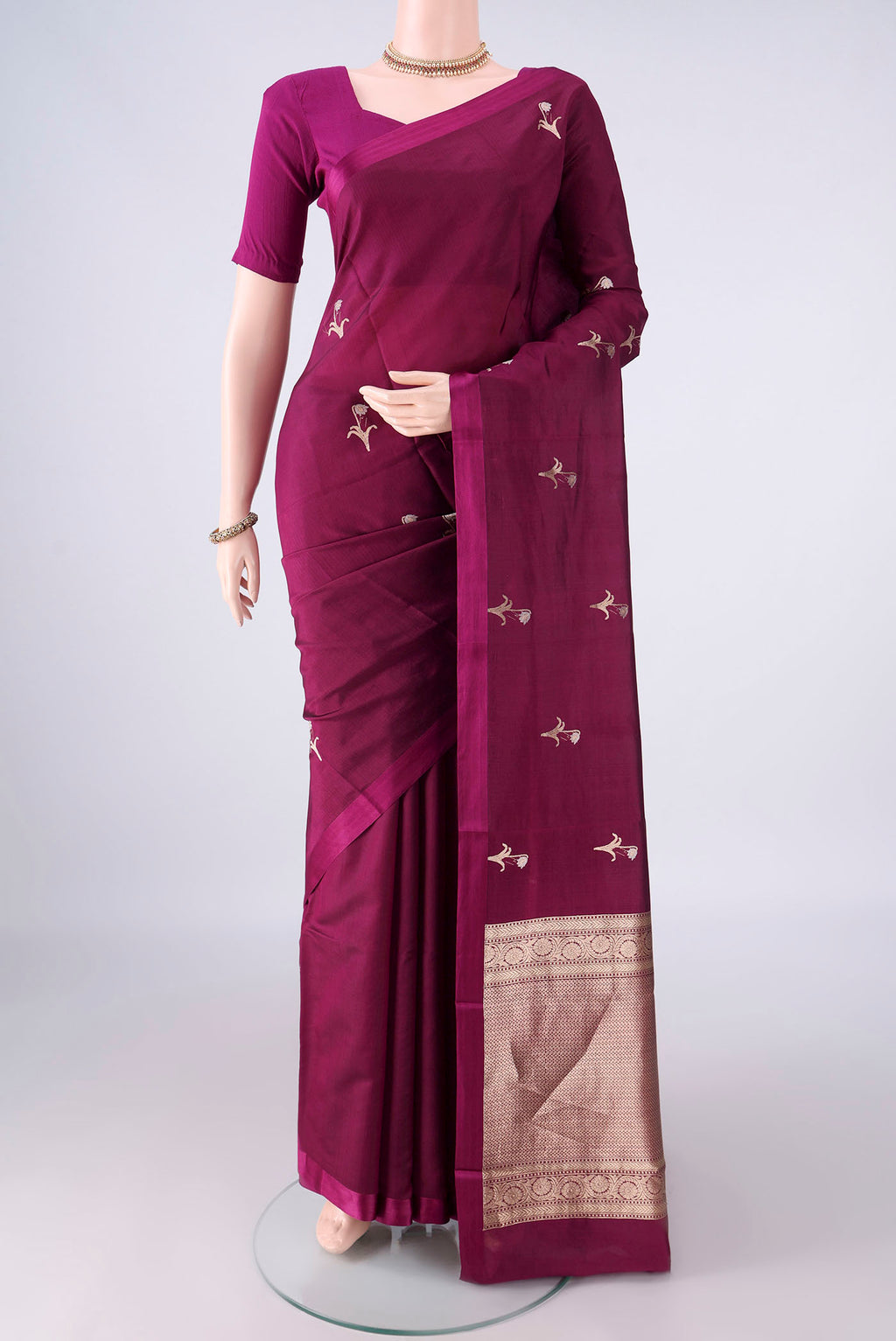 Pure Silk Burgundy Banarasi Katan Saree with Zari And Thread Butta on the body and Without Border.  displayed on a mannequin