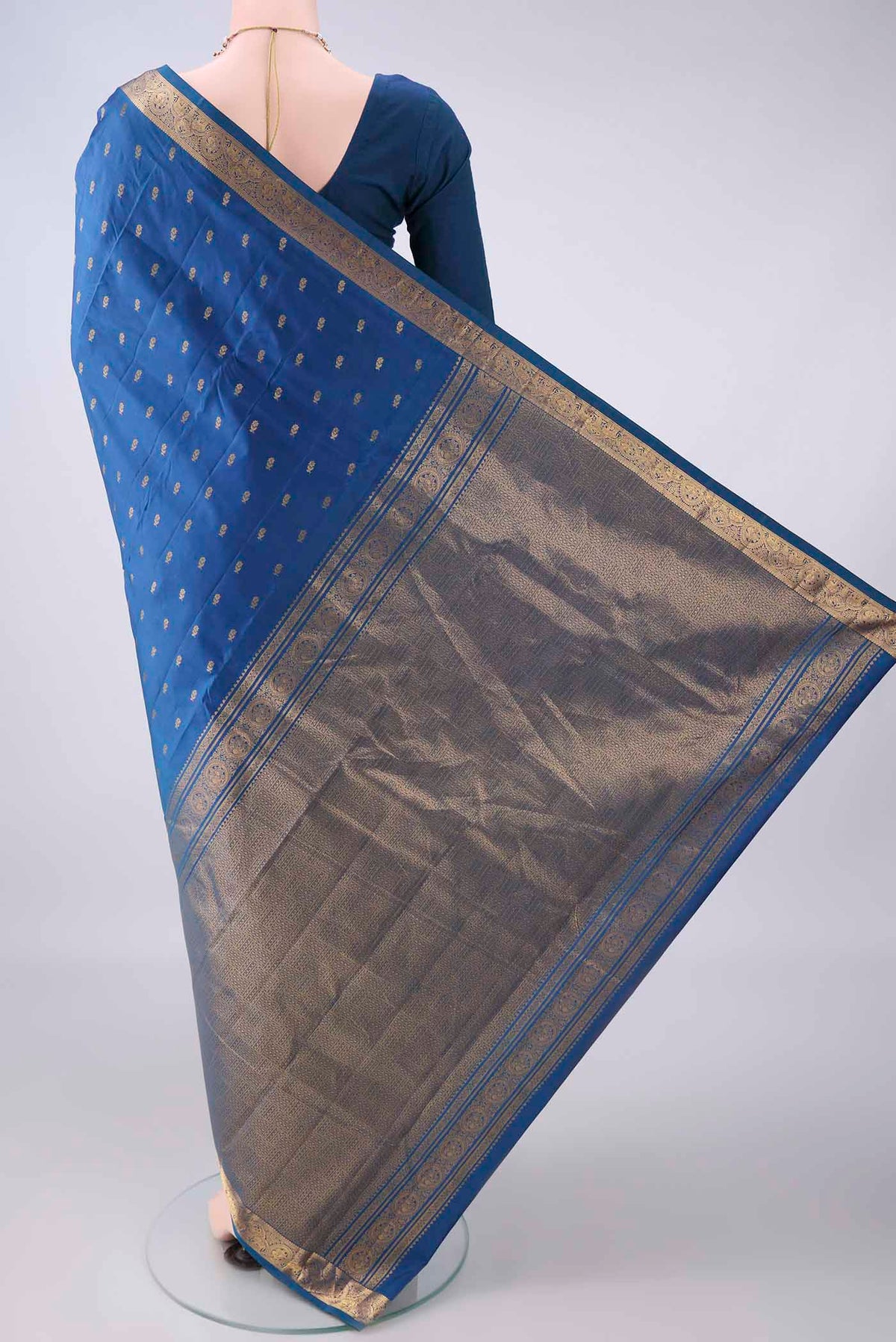 Flat view of Pure Silk Blue Kanjivaram Saree with Zari Butta on the body and Zari Border. 