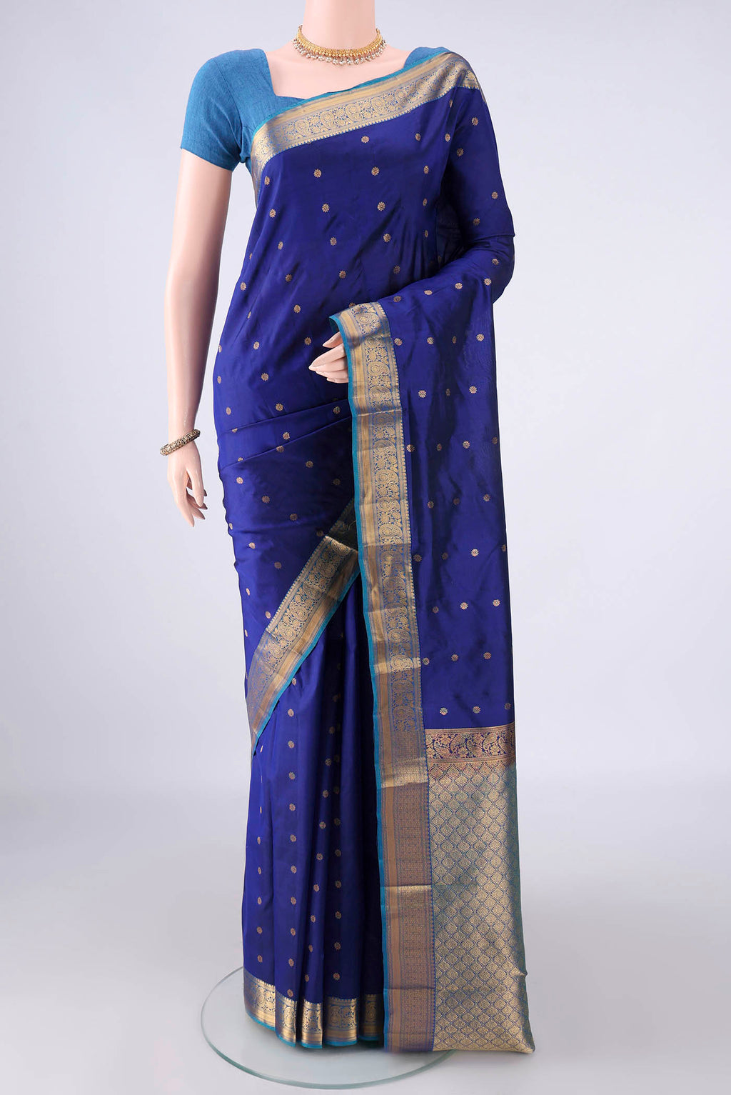 Pure Silk Dark Blue Kanjivaram Saree with Zari Butta on the body and Zari Border.  displayed on a mannequin
