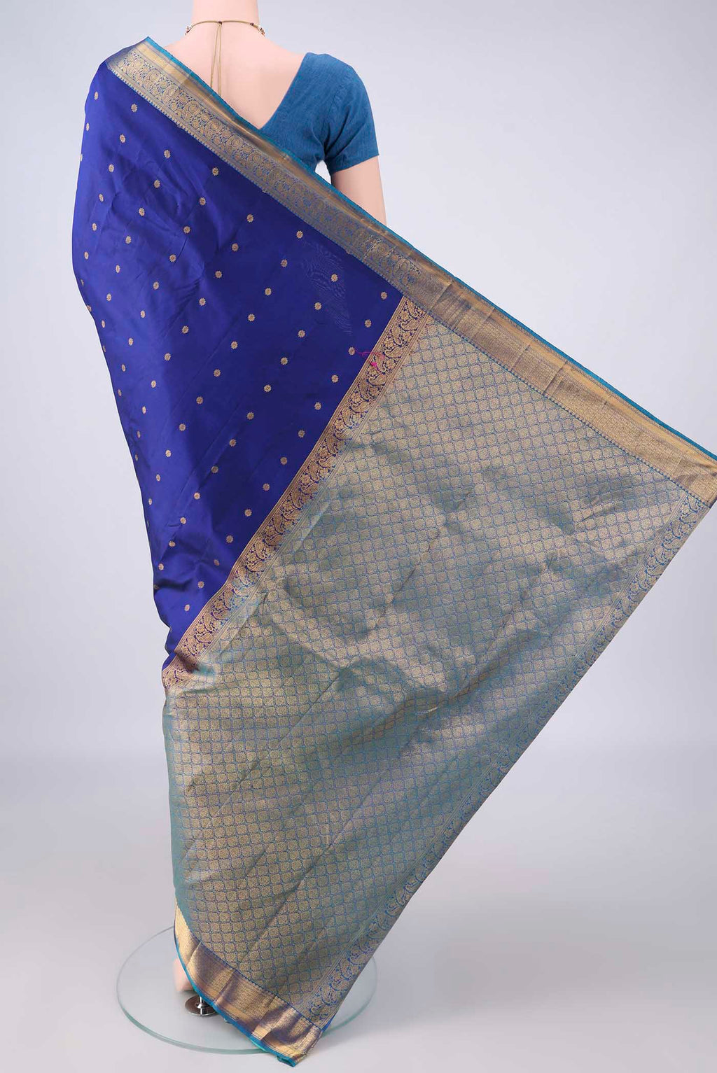Flat view of Pure Silk Dark Blue Kanjivaram Saree with Zari Butta on the body and Zari Border. 