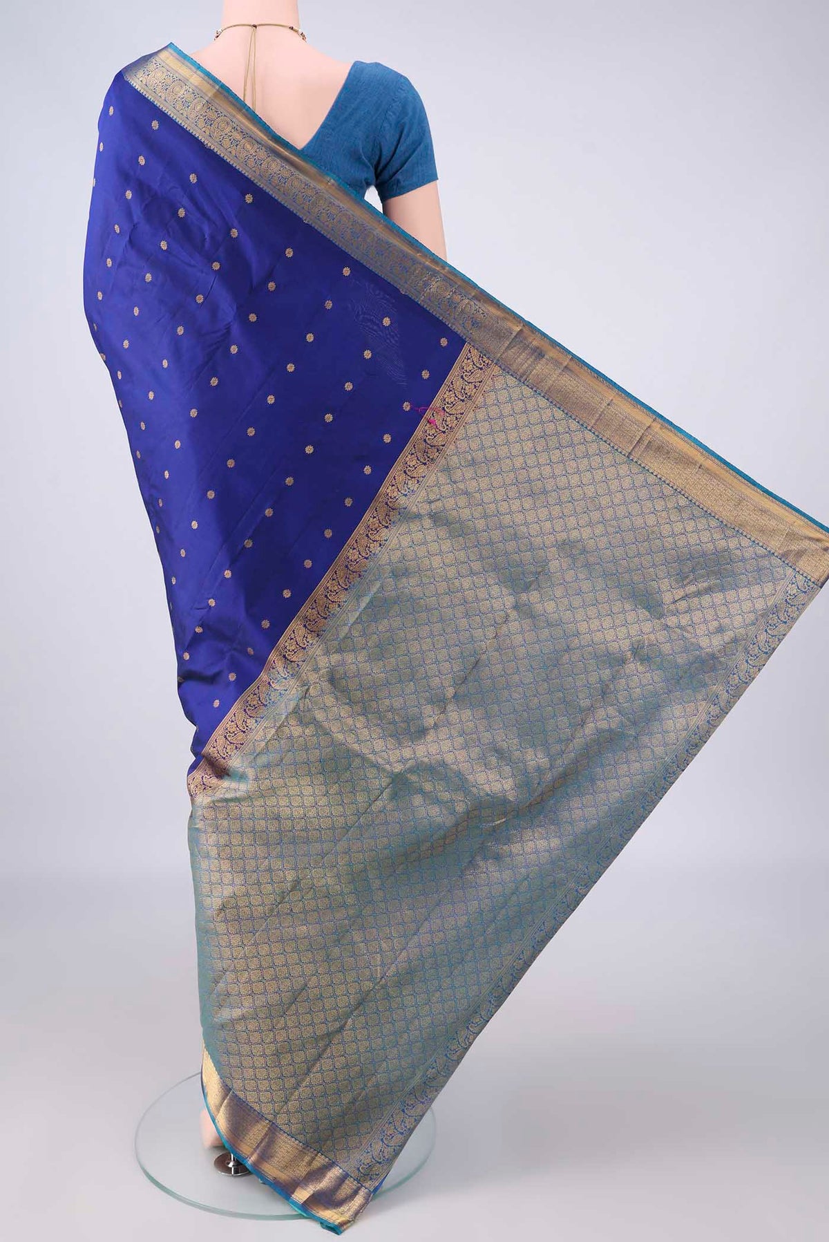 Flat view of Pure Silk Dark Blue Kanjivaram Saree with Zari Butta on the body and Zari Border. 