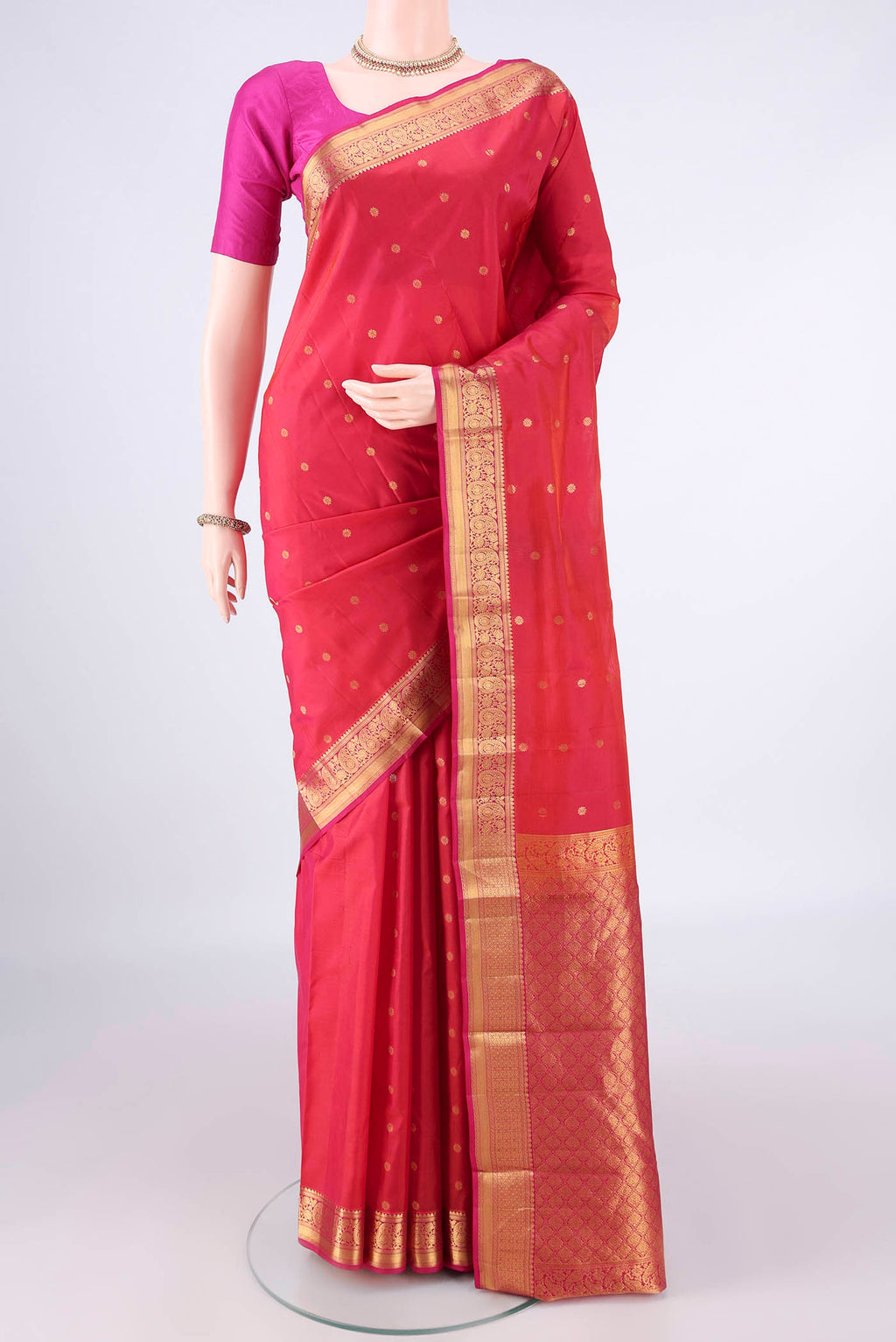Pure Silk Imperial Red Kanjivaram Saree with Zari Butta on the body and Zari Border.  displayed on a mannequin