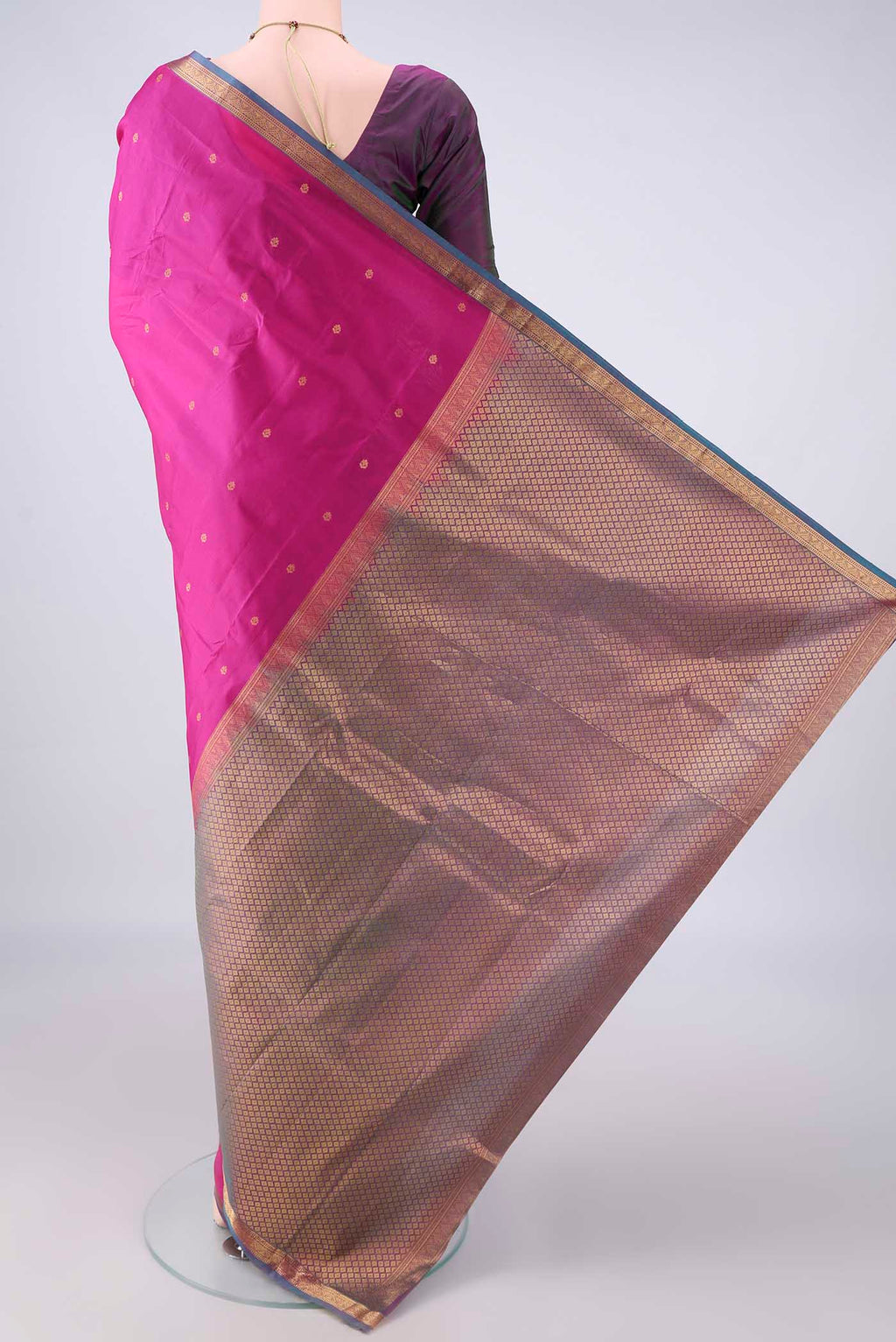 Flat view of Pure Silk Rani Pink Kanjivaram Saree with Zari Butta on the body and Zari Border. 
