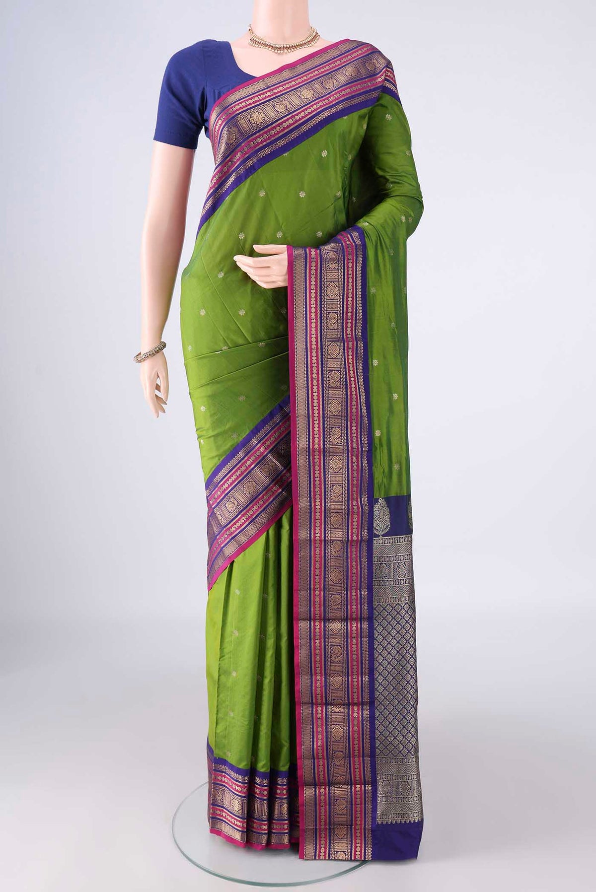 Green Blended Bangalore Silk Saree with Zari Butta on the body and Zari Border.  displayed on a mannequin