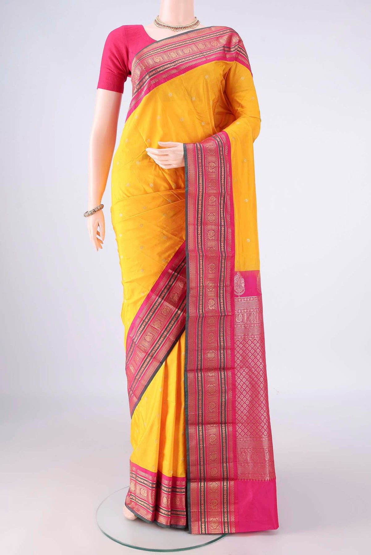 Yellow Blended Bangalore Silk Saree with Zari Butta on the body and Zari Border.  displayed on a mannequin