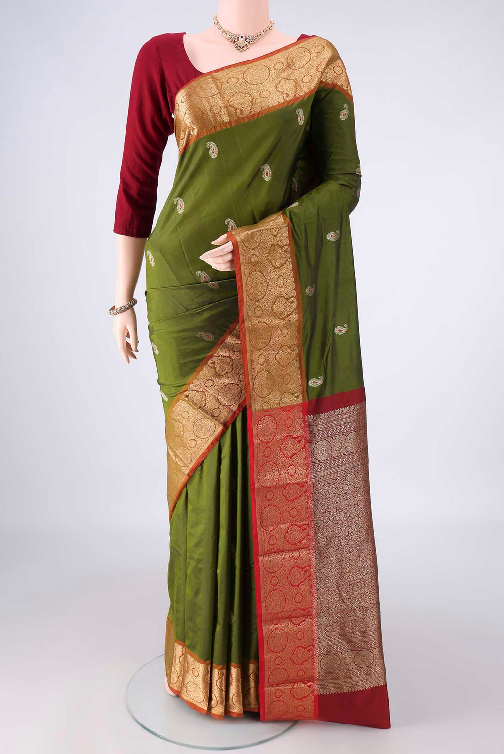 Mehandi Green Blended Bangalore Silk Saree with Zari Butta on the body and Zari Border.  displayed on a mannequin
