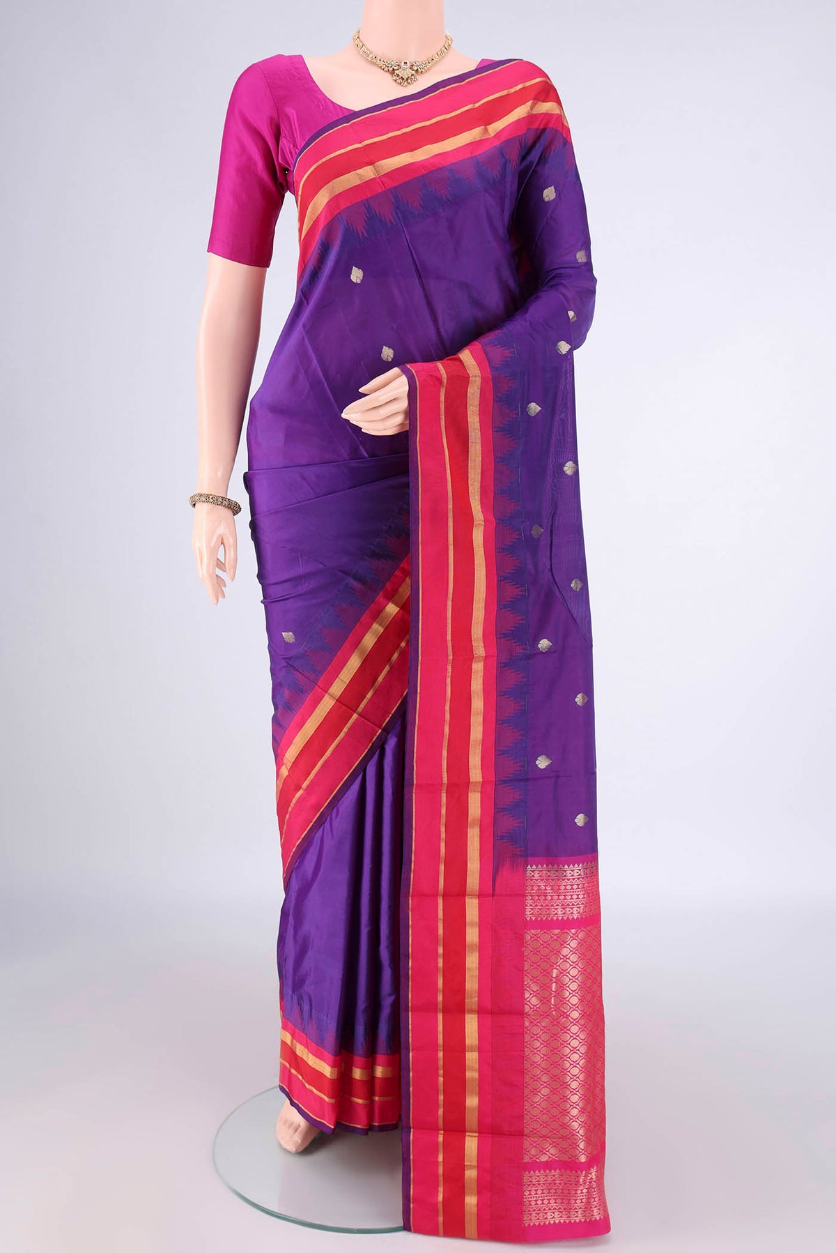 Purple Blended Bangalore Silk Saree with Zari Butta on the body and Temple Border.  displayed on a mannequin