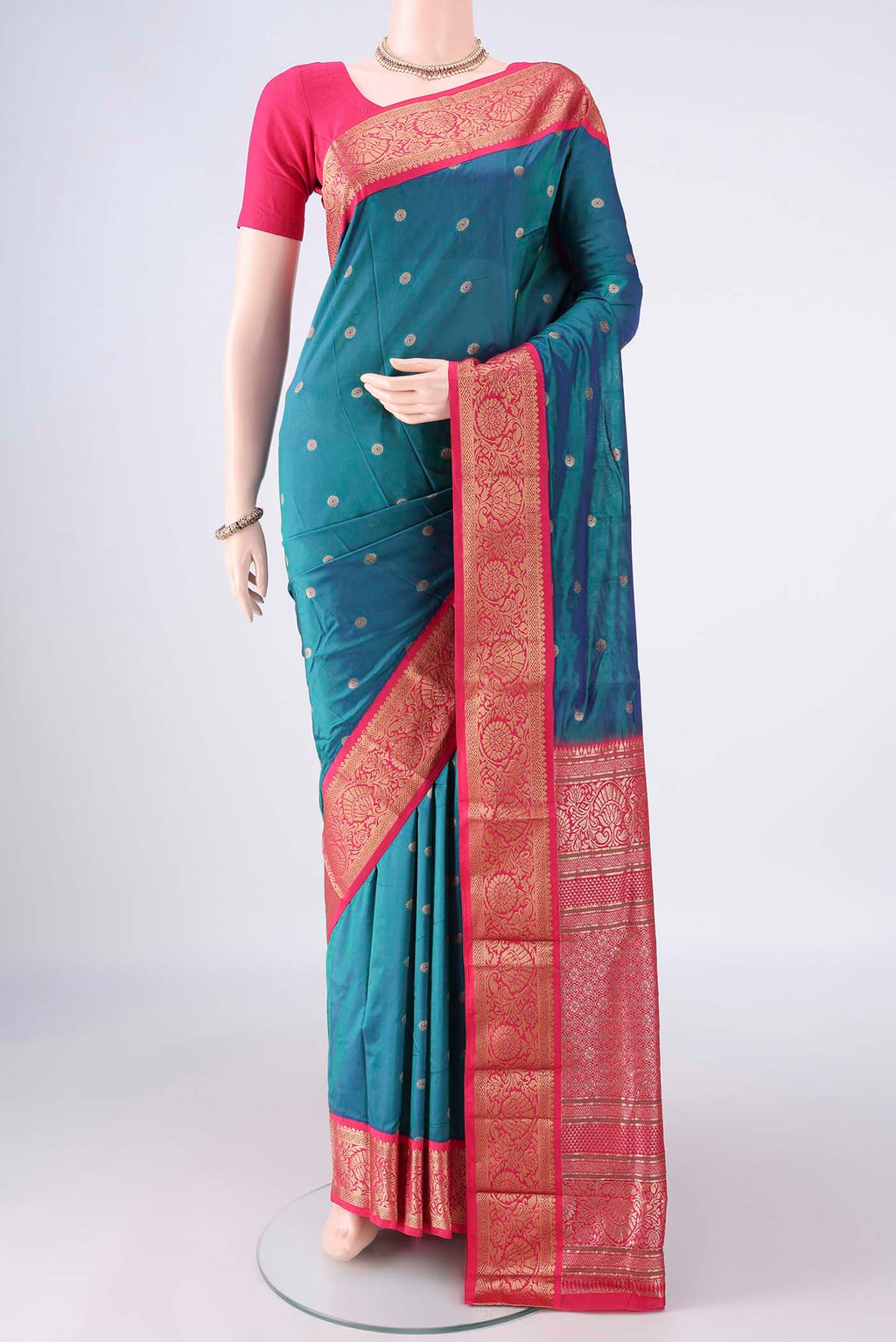 Peacock Blue Blended Bangalore Silk Saree with Zari Butta on the body and Zari Border.  displayed on a mannequin