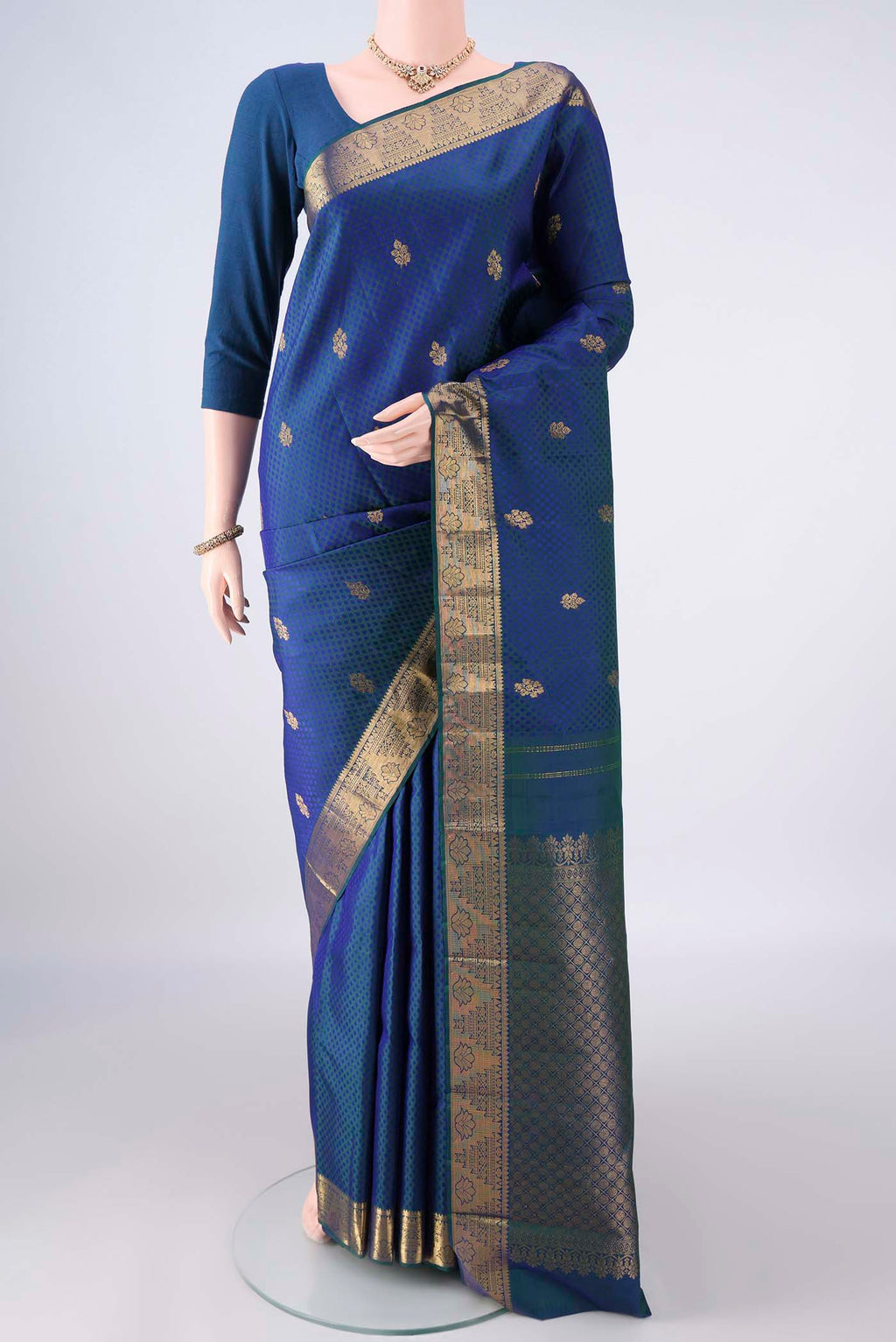 Pure Silk Peacock Blue Kanjivaram Saree with Jacquard With Zari Butta on the body and Zari Border.  displayed on a mannequin