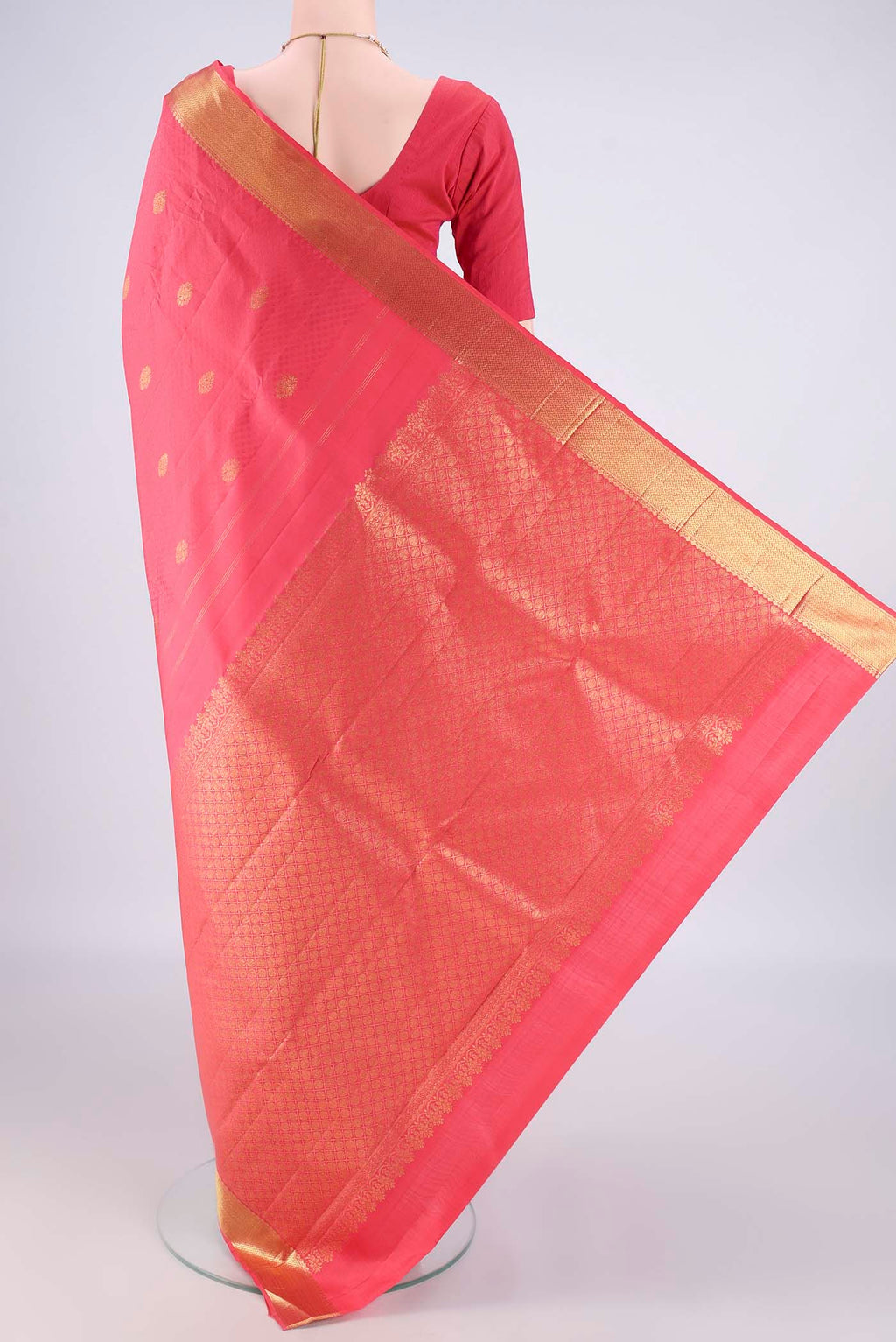 Flat view of Pure Silk Coral Kanjivaram Saree with Jacquard With Zari Butta on the body and Zari Border. 