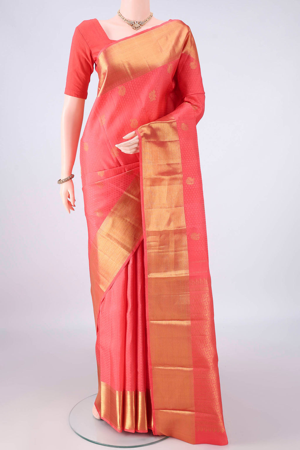 Pure Silk Peach Kanjivaram Saree with Jacquard With Zari Butta on the body and Zari Border.  displayed on a mannequin
