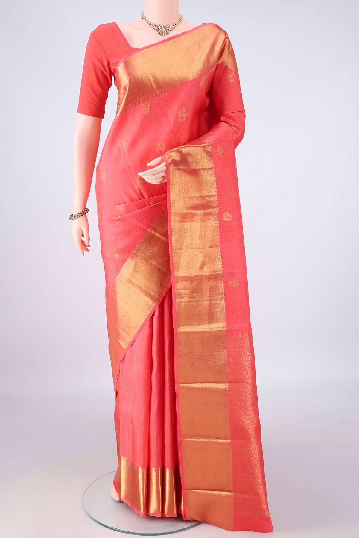 Pure Silk Peach Kanjivaram Saree with Jacquard With Zari Butta on the body and Zari Border.  displayed on a mannequin