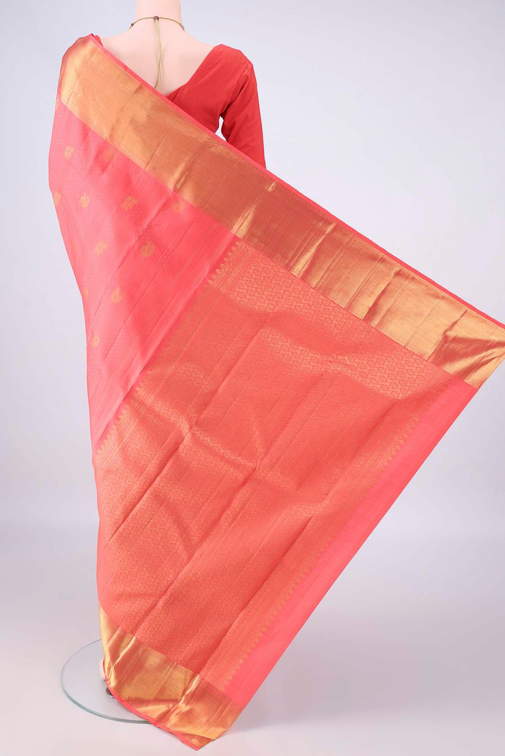 Flat view of Pure Silk Peach Kanjivaram Saree with Jacquard With Zari Butta on the body and Zari Border. 