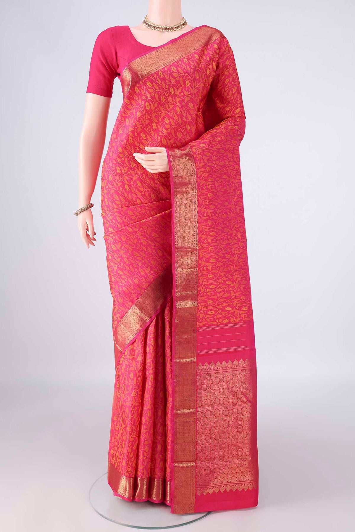 Pure Silk Rani Pink Kanjivaram Saree with Jacquard design on the body and Zari Border.  displayed on a mannequin