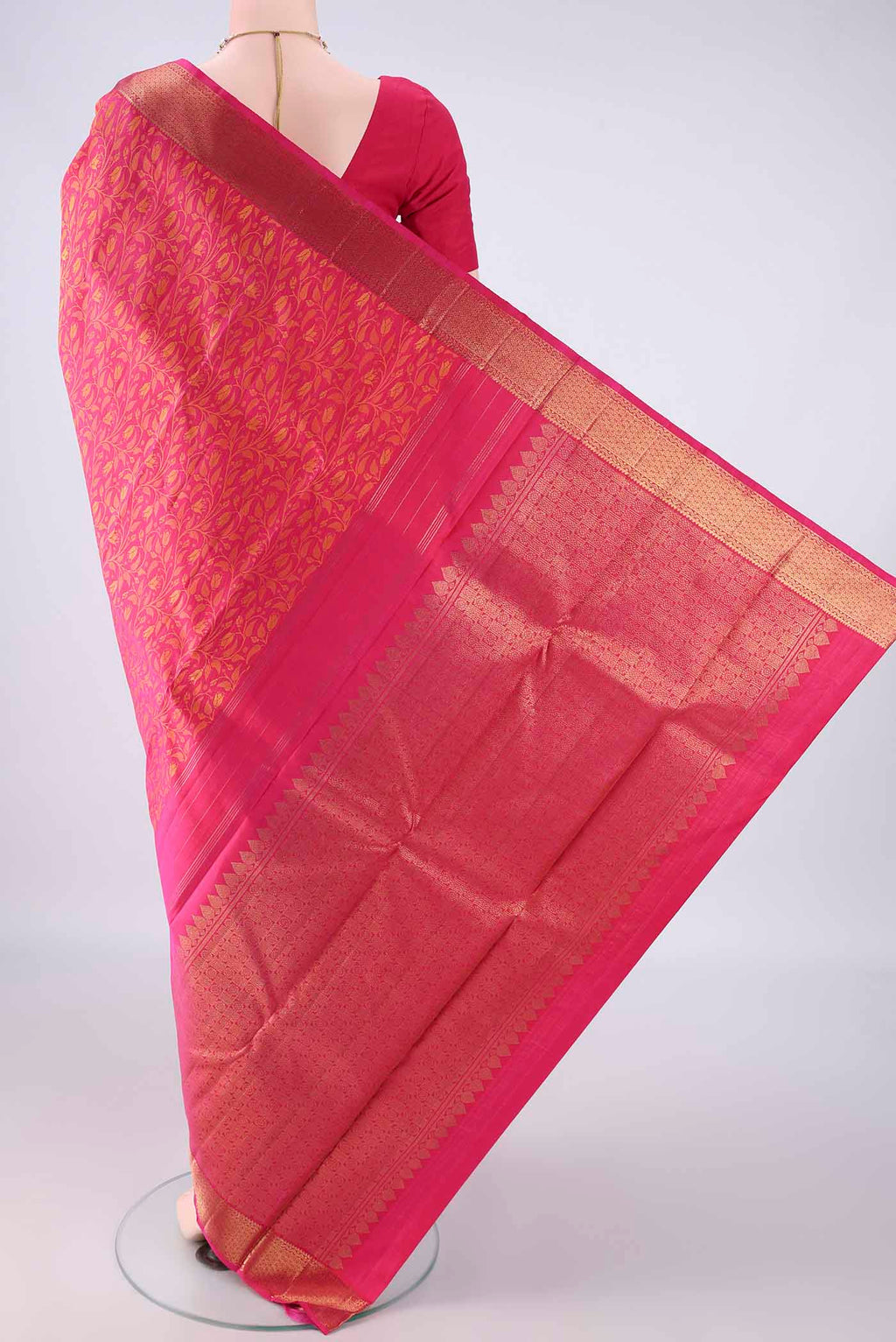 Flat view of Pure Silk Rani Pink Kanjivaram Saree with Jacquard design on the body and Zari Border. 