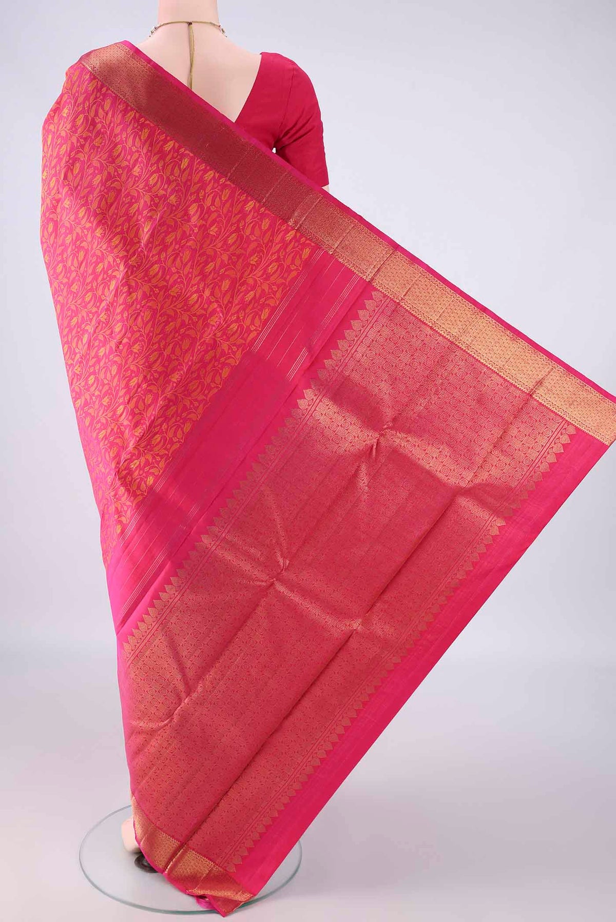 Flat view of Pure Silk Rani Pink Kanjivaram Saree with Jacquard design on the body and Zari Border. 
