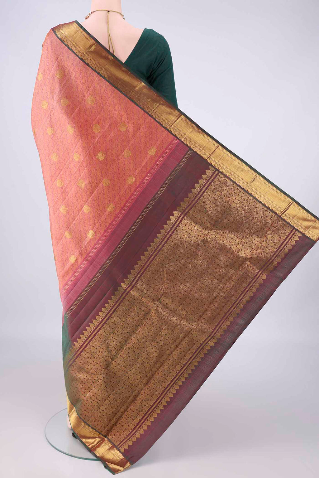Flat view of Pure Silk Coral Kanjivaram Saree with Jacquard With Zari Butta on the body and Zari Border. 