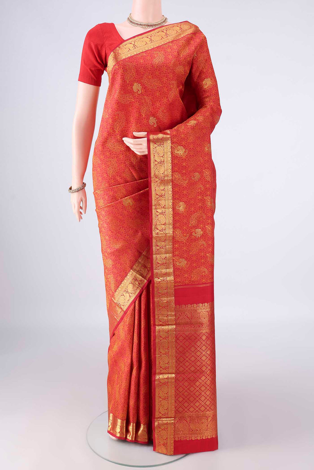 Pure Silk Red Kanjivaram Saree with Jacquard With Zari Butta on the body and Zari Border.  displayed on a mannequin
