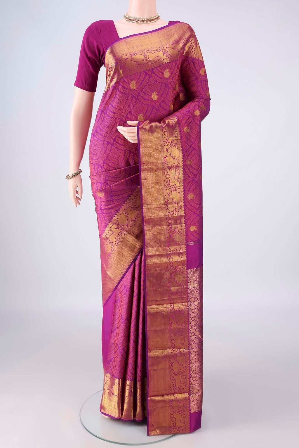 Pure Silk Magenta Kanjivaram Saree with Jacquard With Zari Butta on the body and Zari Border.  displayed on a mannequin