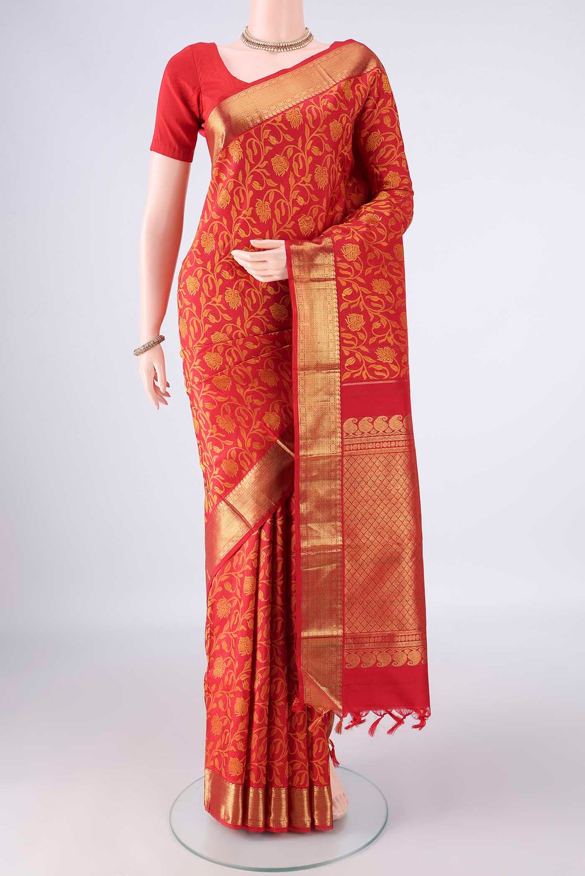 Pure Silk Red Kanjivaram Saree with Jacquard design on the body and Zari Border.  displayed on a mannequin