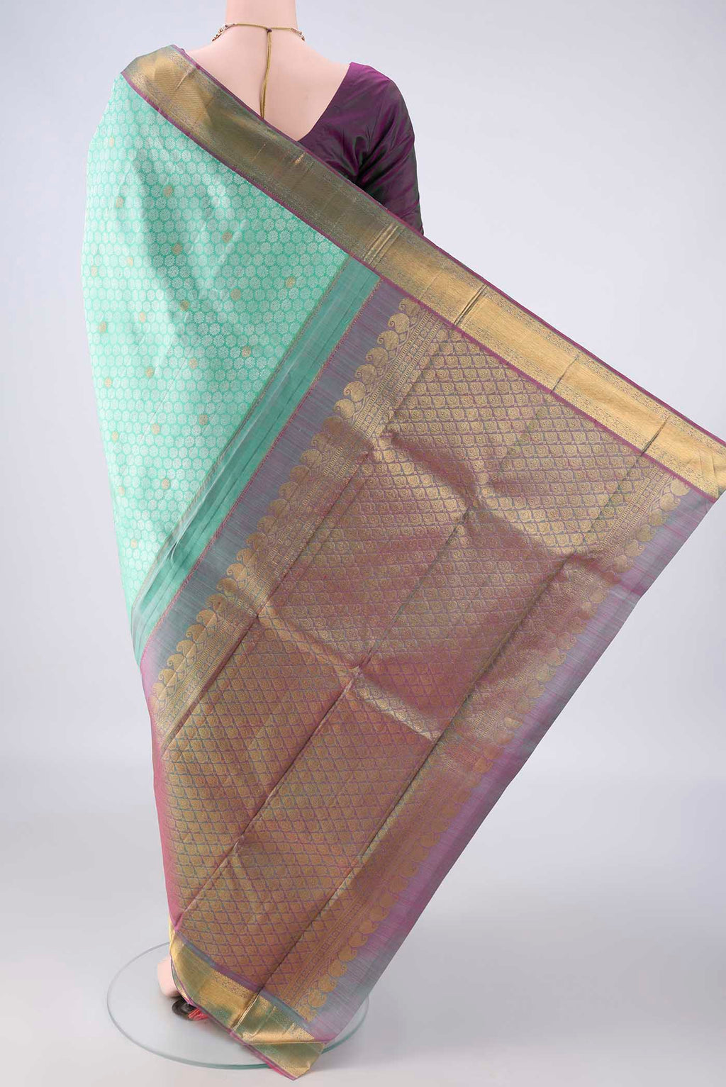 Flat view of Pure Silk Mint Green Kanjivaram Saree with Jacquard With Zari Butta on the body and Zari Border. 