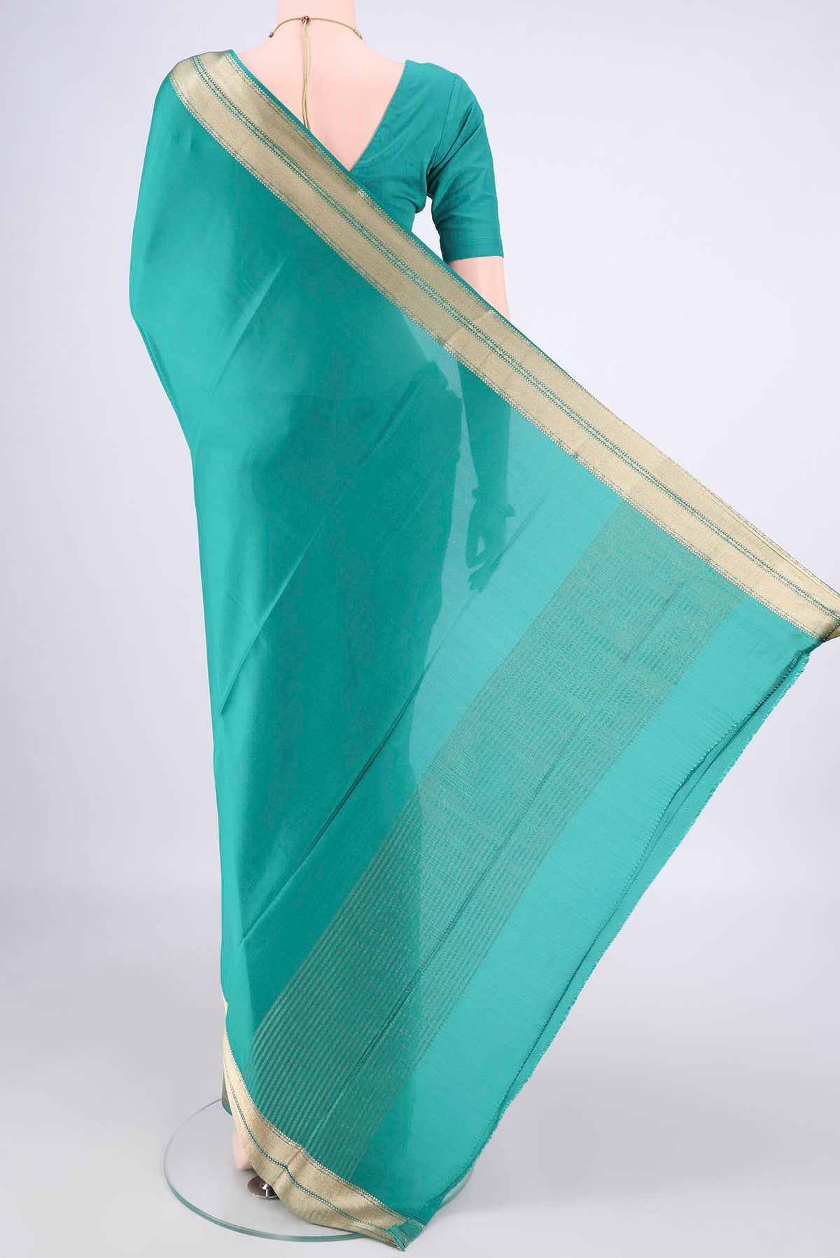 Flat view of Sea Green Mysore Crepe Saree with Plain Body and Zari Border. 