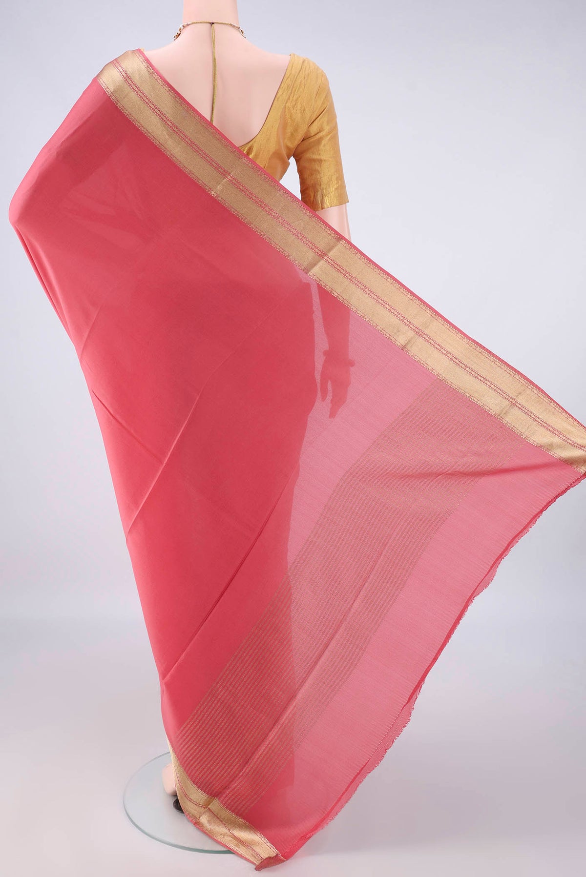 Flat view of Peach Mysore Crepe Saree with Plain Body and Zari Border. 