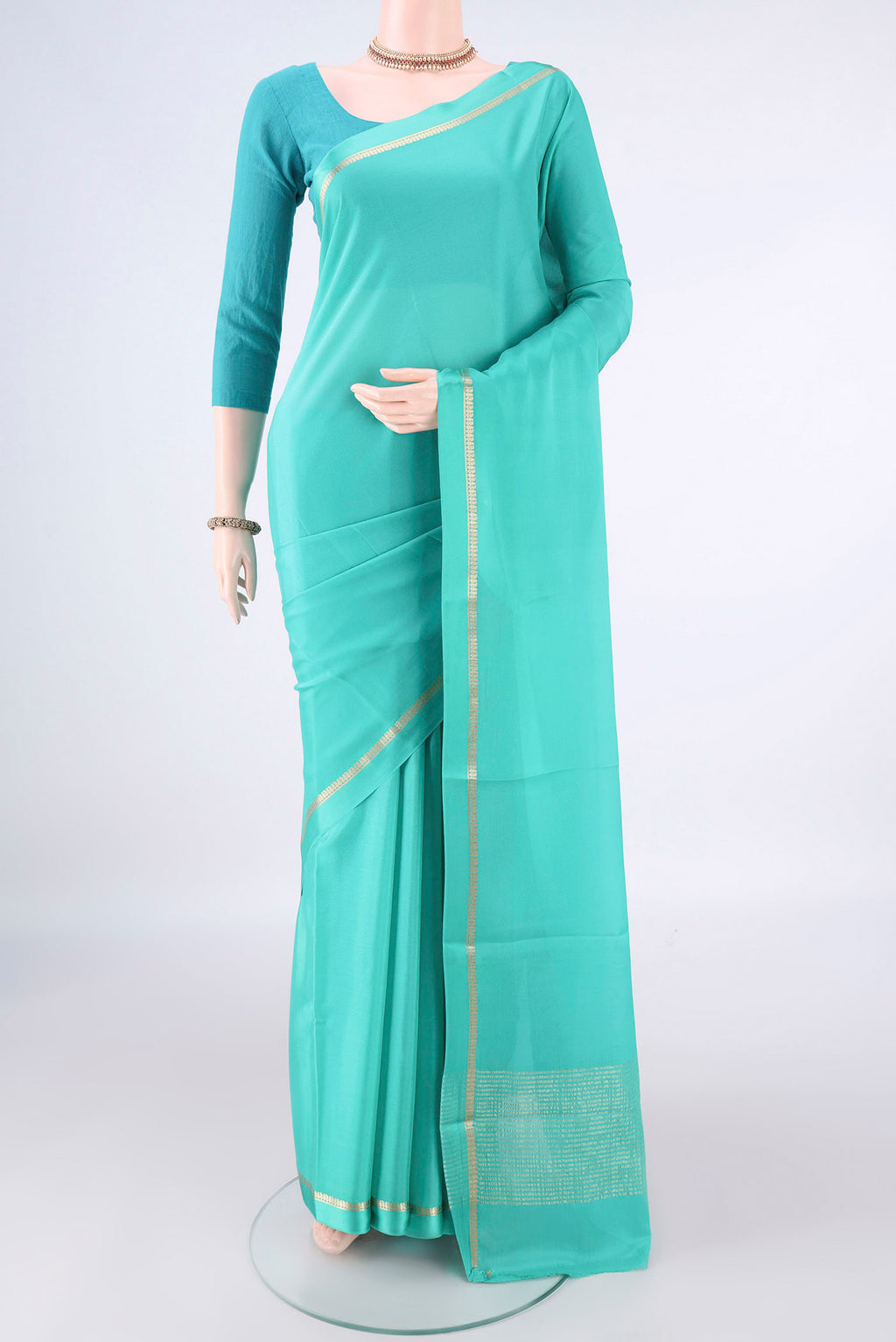 Turquoise Mysore Crepe Saree with Plain Body and Zari Border.  displayed on a mannequin