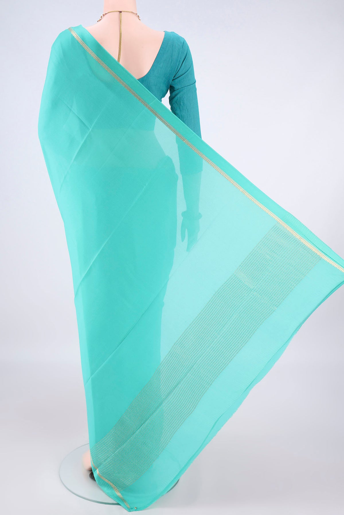 Flat view of Turquoise Mysore Crepe Saree with Plain Body and Zari Border. 
