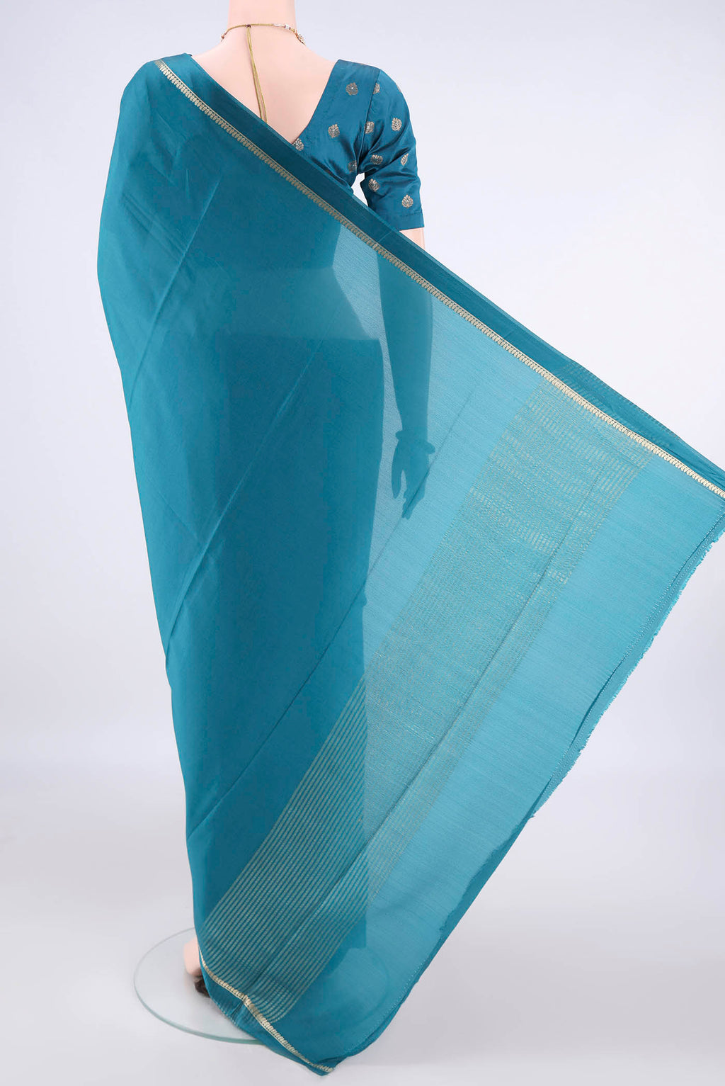 Flat view of Teal Mysore Crepe Saree with Plain Body and Zari Border. 