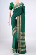 Bottle Green Mysore Crepe Saree with Plain Body and Zari Border.  displayed on a mannequin