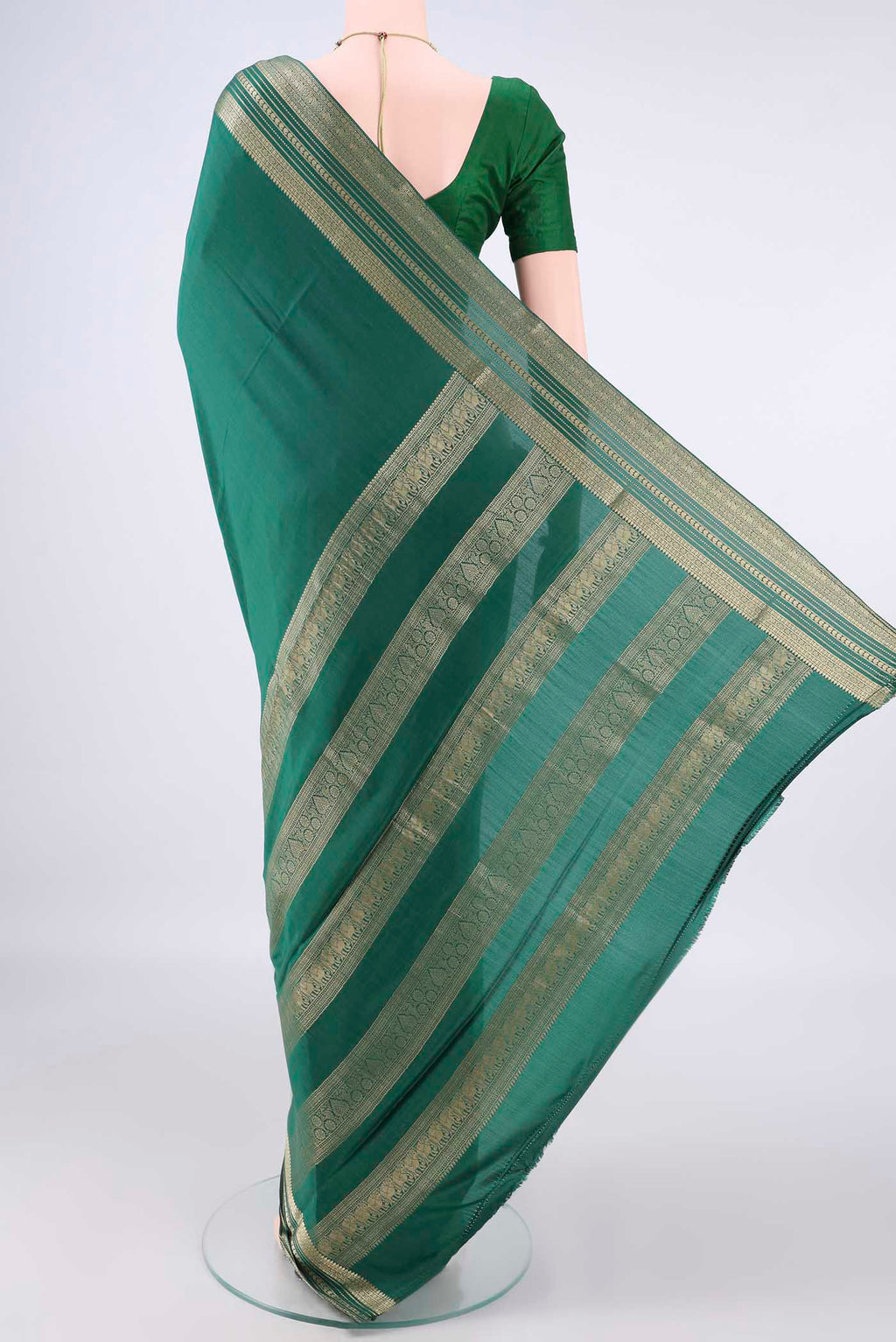 Flat view of Bottle Green Mysore Crepe Saree with Plain Body and Zari Border. 