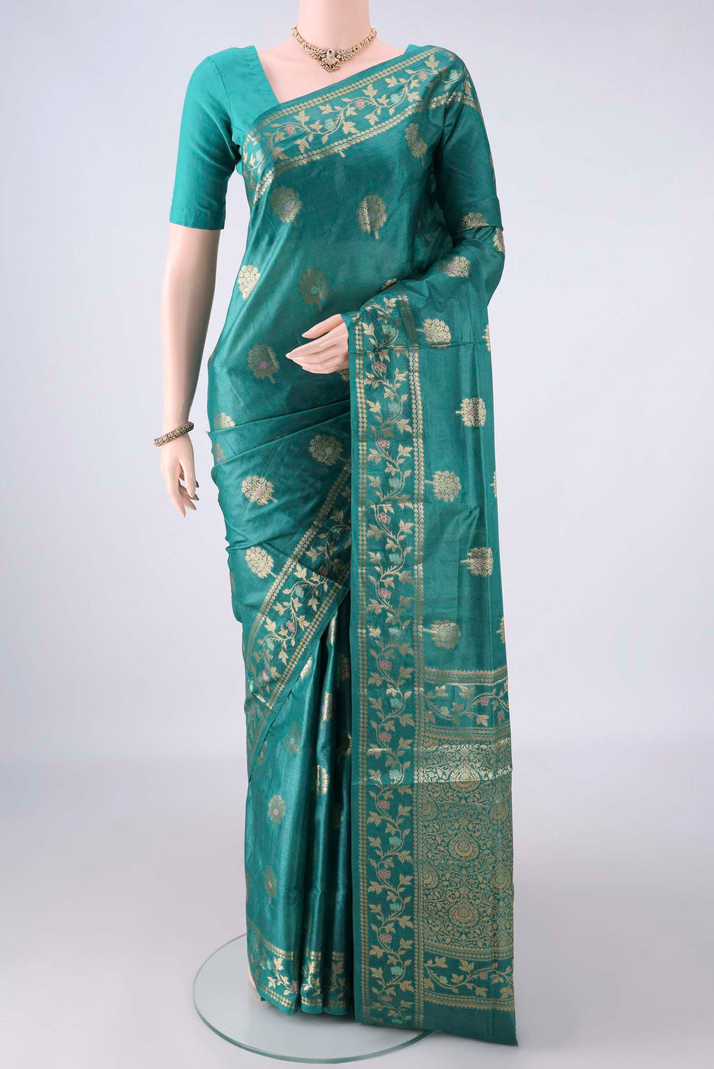 Sea Green Banarasi Tussar Saree with Zari And Thread Butta on the body and Zari And Thread Border.  displayed on a mannequin