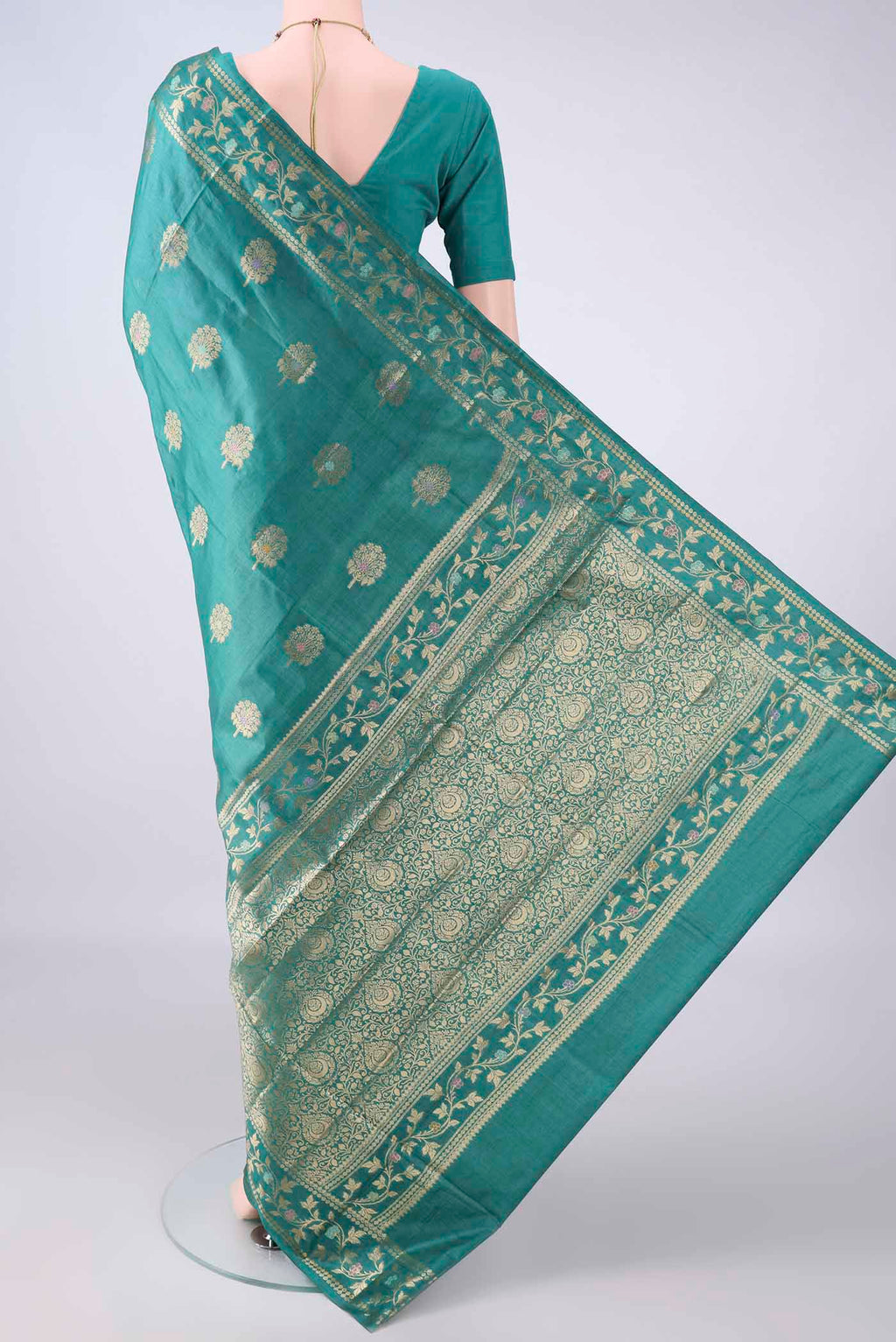 Flat view of Sea Green Banarasi Tussar Saree with Zari And Thread Butta on the body and Zari And Thread Border. 
