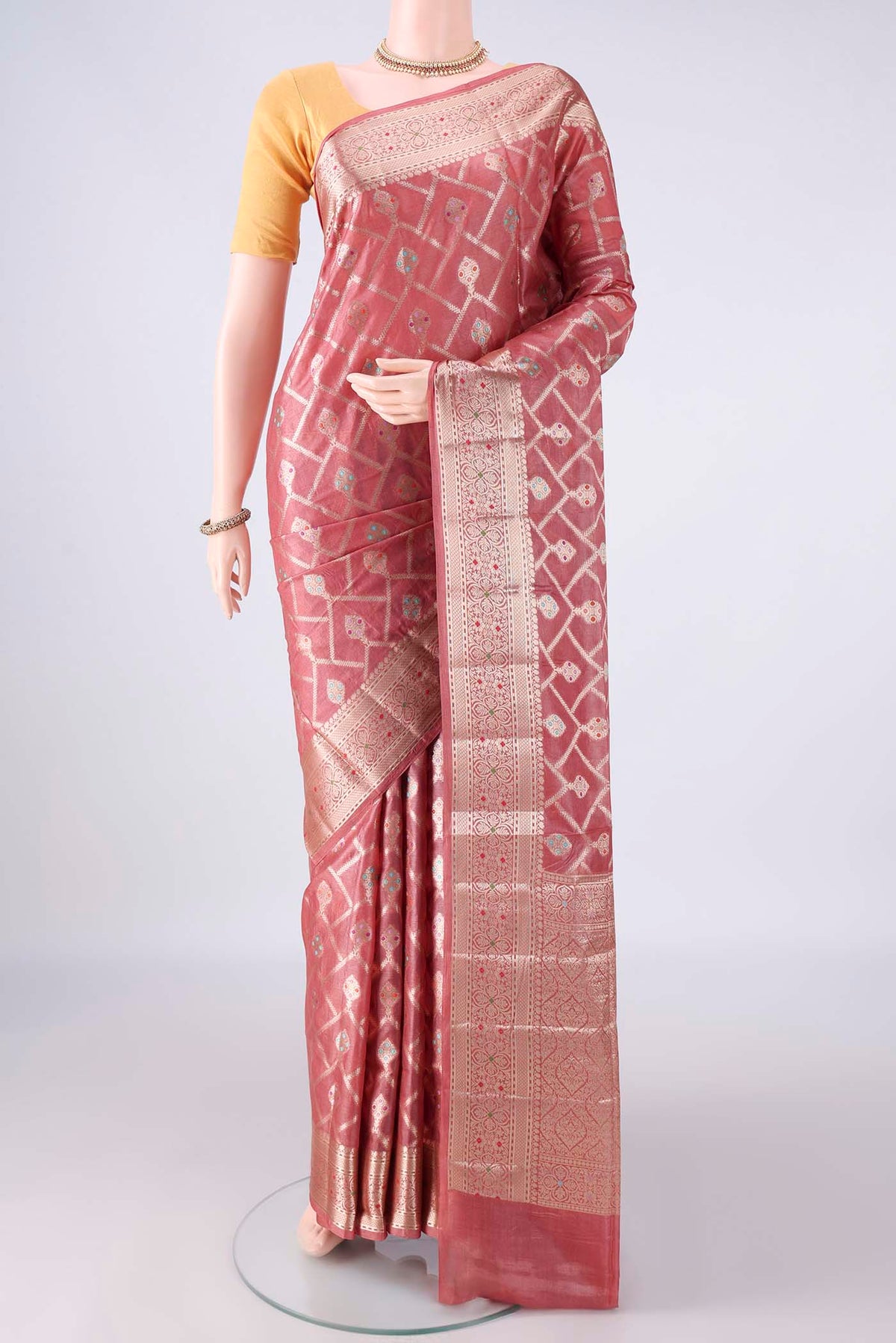 Coral Banarasi Tussar Saree with Zari Brocade on the body and Zari And Thread Border.  displayed on a mannequin