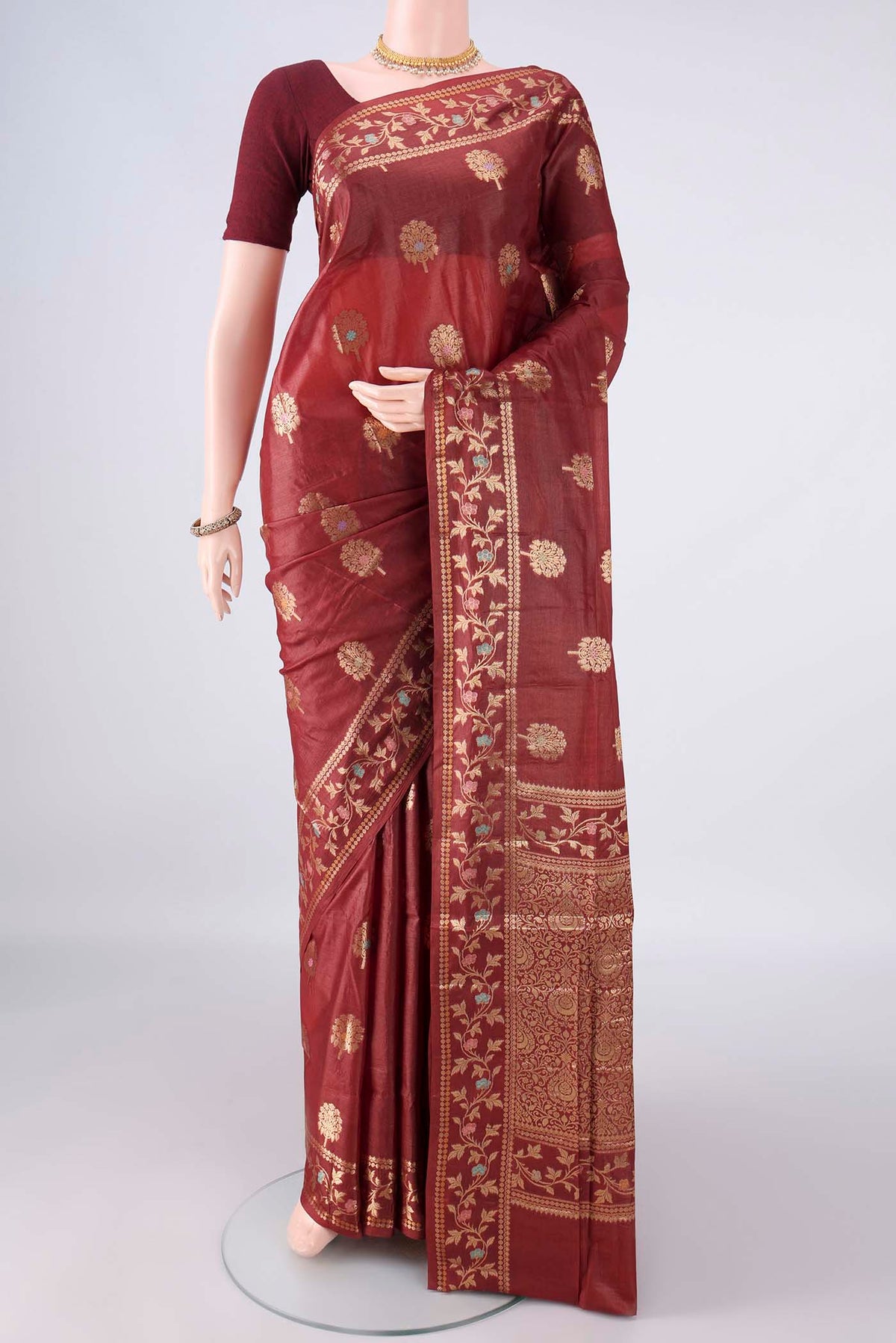 Maroon Banarasi Tussar Saree with Zari Butta on the body and Zari And Thread Border.  displayed on a mannequin