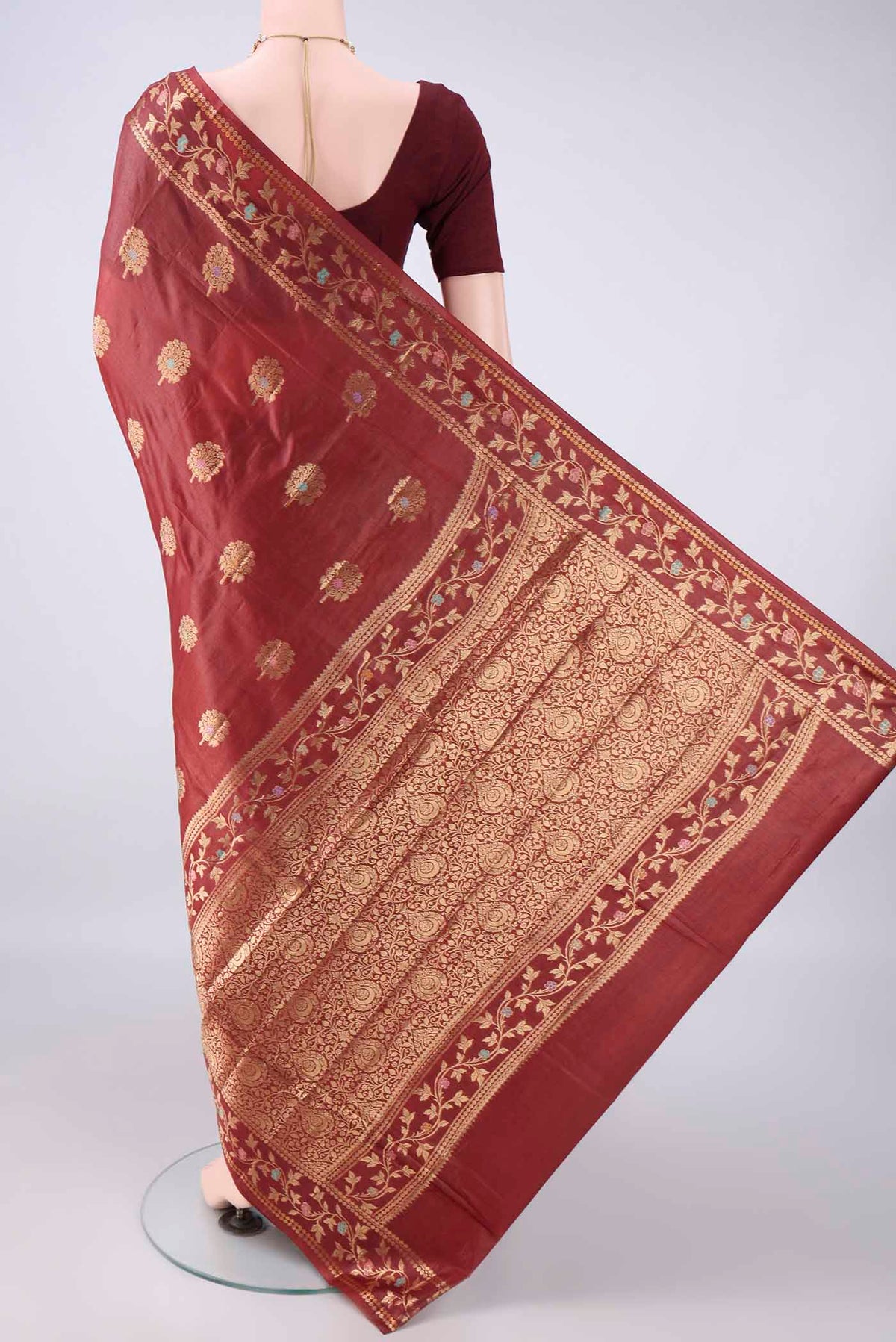 Flat view of Maroon Banarasi Tussar Saree with Zari Butta on the body and Zari And Thread Border. 