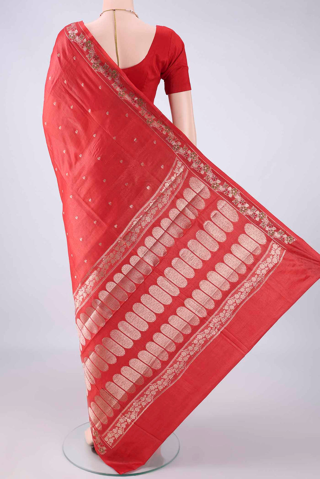 Flat view of Red Banarasi Tussar Saree with Zari Butta on the body and Zari And Thread Border. 