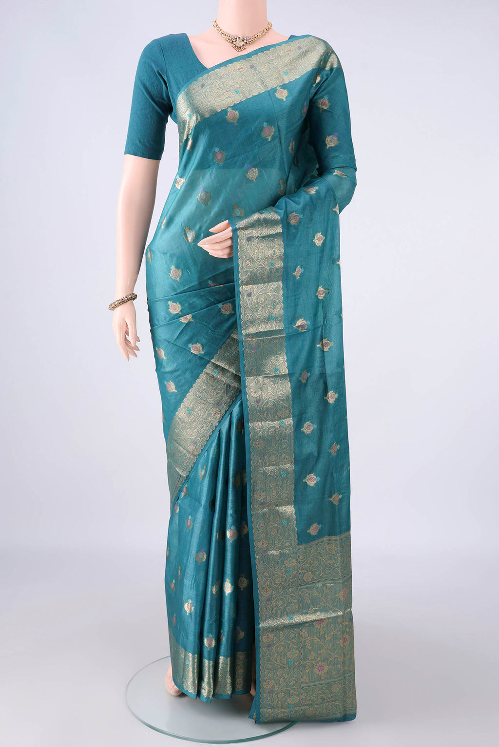 Teal Banarasi Tussar Saree with Zari Brocade on the body and Zari And Thread Border.  displayed on a mannequin