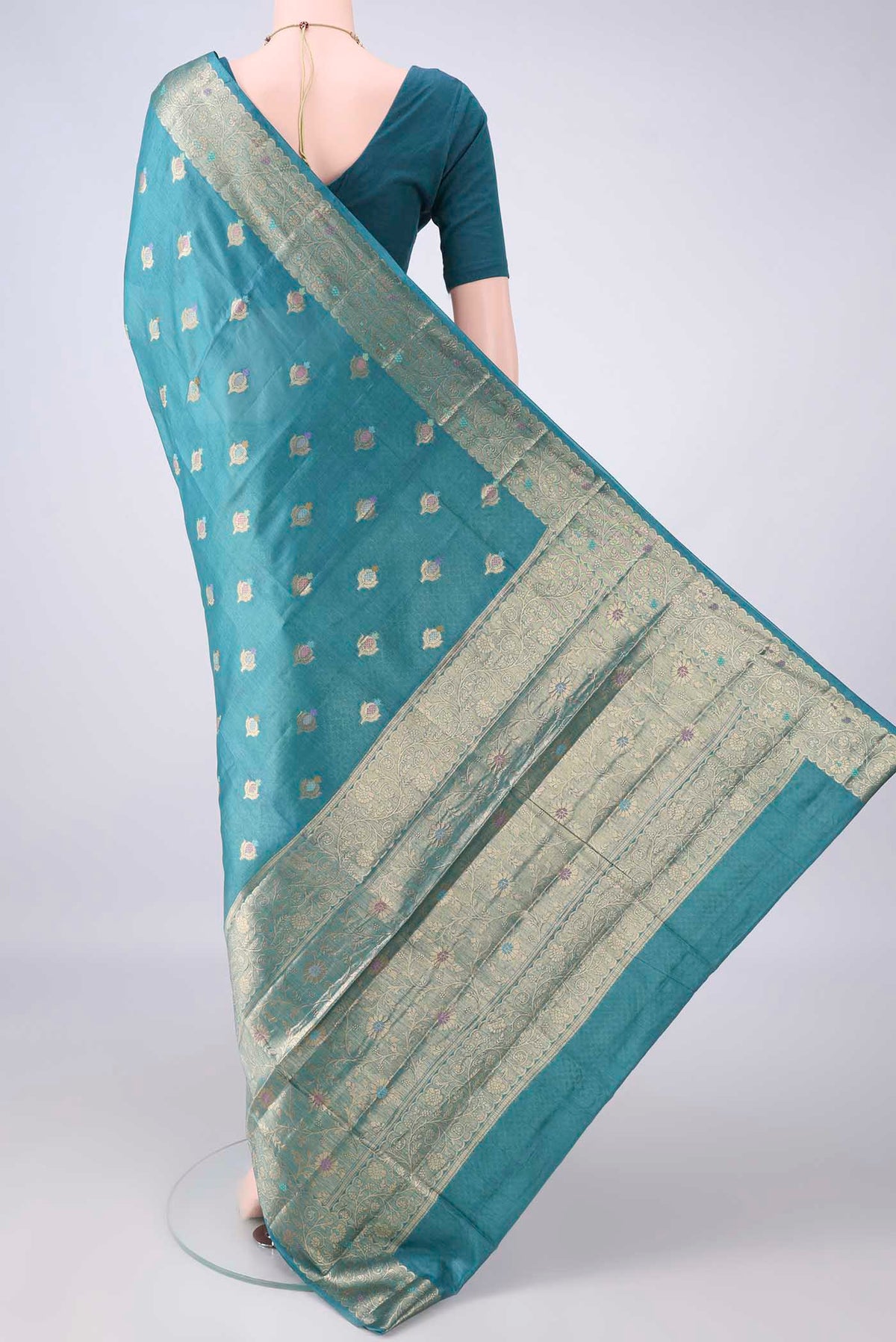 Flat view of Teal Banarasi Tussar Saree with Zari Brocade on the body and Zari And Thread Border. 