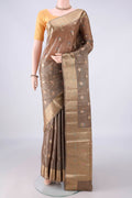 Beige Banarasi Tussar Saree with Zari Butta on the body and Zari And Thread Border.  displayed on a mannequin