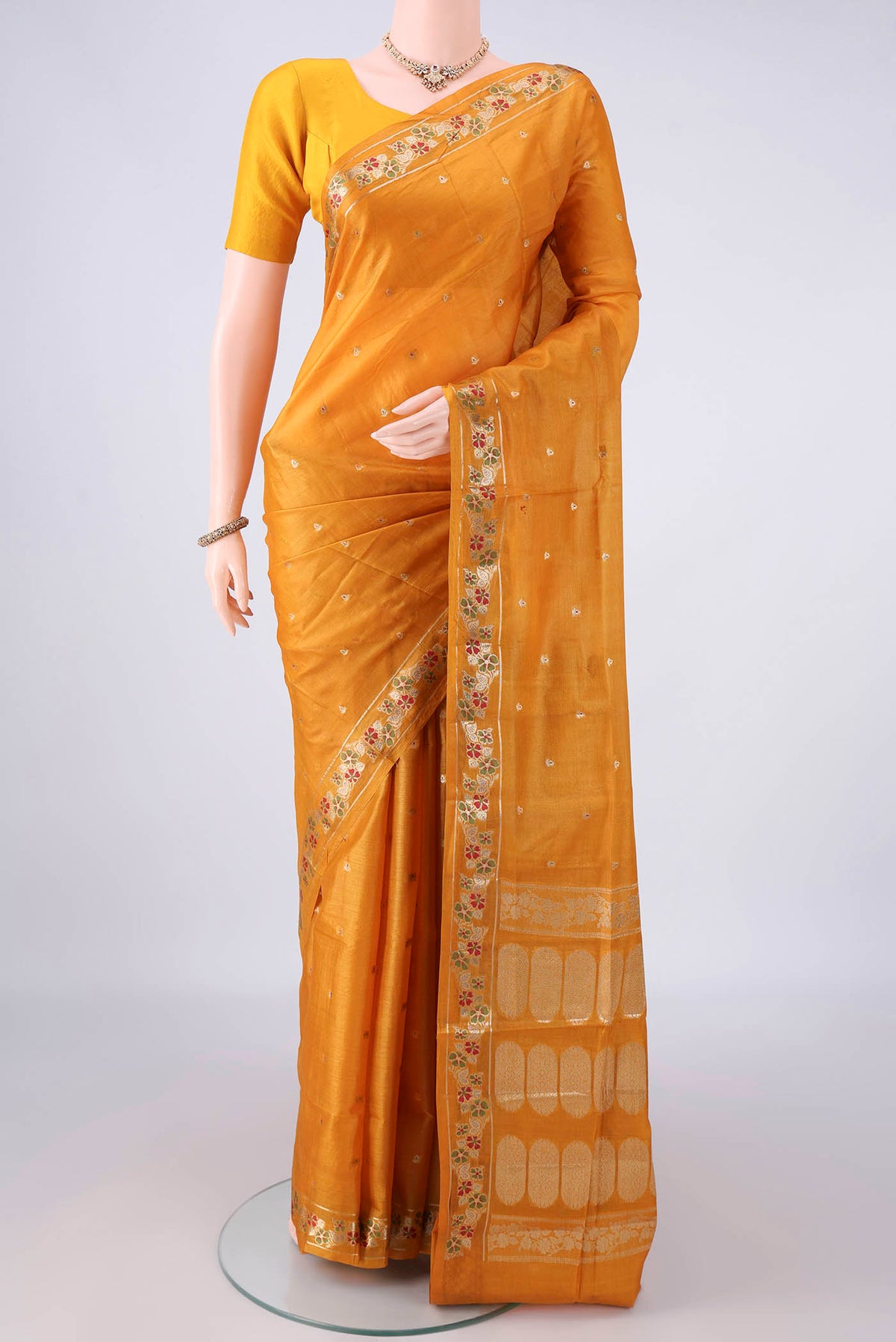 Mustard Banarasi Tussar Saree with Zari Butta on the body and Zari And Thread Border.  displayed on a mannequin