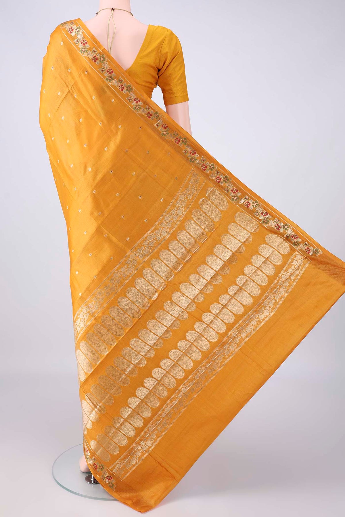 Flat view of Mustard Banarasi Tussar Saree with Zari Butta on the body and Zari And Thread Border. 