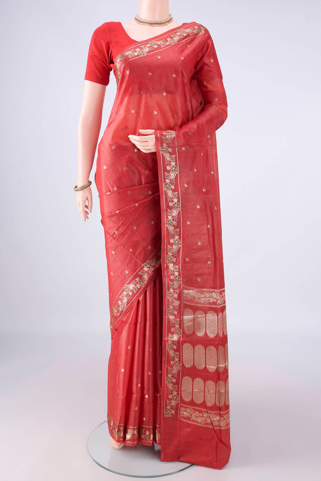 Brick Orange Banarasi Tussar Saree with Zari Butta on the body and Zari And Thread Border.  displayed on a mannequin